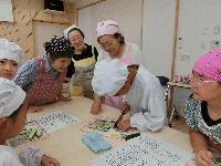 きゅうりを切る子ども達と見守る推進員達 きゅうりを切る子ども達と見守る推進員達